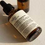 Brown glass bottle with dropper labeled 'Dafèe' on a light background