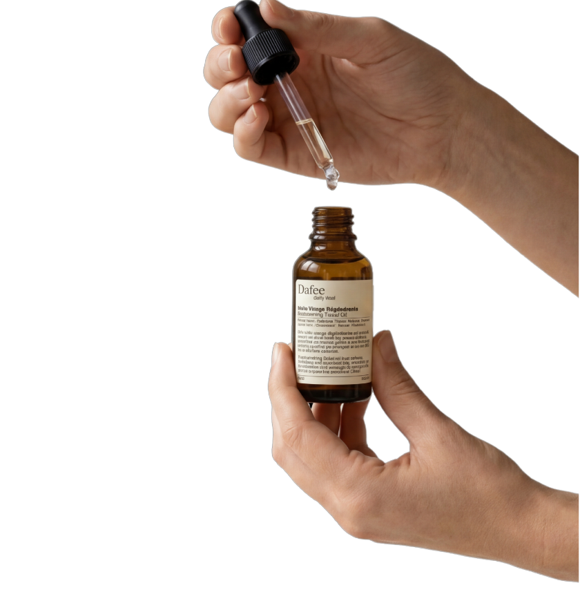 Hand holding a dropper bottle with a label over a plain background